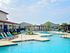 Luxurious swimming pool with stylish lounge chairs and modern cabanas, perfect for relaxation and enjoying sunny days.
