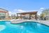 Inviting outdoor pool area with a stylish pergola and comfortable seating, perfect for relaxation and entertainment.