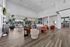 Chic modern lounge with plush seating, vibrant decor, and floor-to-ceiling windows overlooking a serene outdoor area.