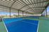 Eight covered and lighted Pickleball courts with high ceilings and abundant natural light, surrounded by scenic greenery for an active lifestyle.
