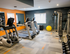 Modern apartment gym with state-of-the-art treadmills, weight machines, and fitness equipment.