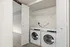 Elegant in-home laundry setup with modern washer and dryer in a sleek, compact space.