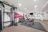 Modern fitness center at Webster Hall featuring top-of-the-line gym equipment, free weights, and cardio machines in a spacious, well-lit environment.