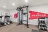 Modern fitness center at Webster Hall featuring state-of-the-art exercise equipment, including treadmills, weight machines, and free weights, set in a bright and inviting space.