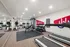 Modern fitness center featuring state-of-the-art treadmills, elliptical machines, and a versatile weight training area with a sleek design.