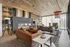 Chic and cozy living room with modern sofas, a sleek fireplace, ambient lighting, and rustic wood accents, perfect for relaxation.