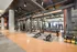 Modern fitness center with state-of-the-art equipment, free weights, and a mirrored wall, perfect for an invigorating workout experience.