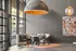 Sophisticated lobby featuring a cozy seating nook with a modern pendant light and vibrant artwork enhancing the chic ambiance.