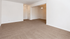Inviting living area with plush carpet and soft lighting, ideal for relaxation and entertaining.