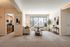 Bright and welcoming living room with modern decor, large window, and cozy seating area adjacent to a functional kitchen.