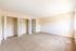Spacious, sunlit bedroom with dual closets and plush carpeting for modern living.
