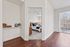 Bright and inviting apartment featuring a cozy bedroom with elegant decor, hardwood floors, and a scenic balcony view.