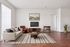 Chic living room with elegant furniture, modern TV setup, and warm wooden flooring, perfect for relaxation and entertainment.