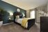 Luxurious bedroom with a stylish bed, chic decor, and contemporary lighting.