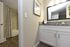 Chic modern bathroom featuring granite countertops, framed mirror, and stylish decor.