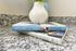 Granite kitchen countertop with a white vase and stacked cookbooks.