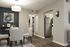 Stylish dining area with contemporary art, modern lighting, and open access to a sleek kitchen.