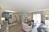 Inviting open-concept living and dining area with modern furniture and natural lighting.