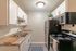 Modern kitchen with sleek stainless steel appliances, white cabinetry, and elegant countertops.