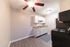 Modern kitchen with sleek white cabinets, elegant countertop, and stainless steel appliances.