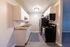 Modern kitchen featuring sleek black appliances, white cabinets, and stylish countertops.