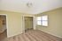 Bright bedroom featuring a spacious closet and large window with natural light.