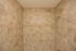 Stylish shower enclosure featuring refined beige tilework and a decorative trim.