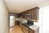 Contemporary kitchen with stainless steel appliances, granite countertops, and elegant dark wood cabinetry.
