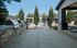 Inviting outdoor patio area featuring modern grills and a view of the glistening pool beyond.