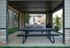 Inviting covered pavilion with picnic tables and grills, perfect for outdoor gatherings.