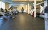 Spacious fitness center with treadmills, exercise bikes, and a cardio machine in a well-lit room.