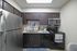 Sleek modern kitchen with dark wood cabinets, stainless steel appliances, and granite countertops.