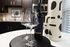 Elegant kitchen setup featuring two wine glasses, a bottle of wine, and modern abstract decor.