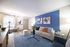 Bright and welcoming living room with modern furniture and a blue accent wall.