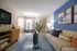 Bright and stylish living room with modern decor, featuring a comfortable sofa, elegant coffee table, and a dining area by the window.