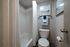 Contemporary bathroom with a bathtub, white tiles, and elegant decor.