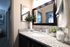 Chic bathroom vanity with granite countertop and stylish mirror.