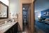 Chic bathroom interior leading to a cozy living area with stylish decor.
