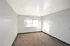 Bright and spacious room with plush carpeting, large window, and fresh paint, offering a serene ambiance.