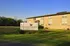 Inviting Eagle Crossing Apartments with charming brick exterior, nestled in a scenic, lush green setting.