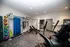Modern fitness room with exercise equipment, colorful medicine balls, and a stretching area, ideal for an active lifestyle.