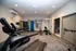 Modern apartment gym featuring state-of-the-art exercise equipment, including treadmills, weights, and a multi-functional workout station.