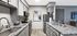 Chic modern kitchen with elegant granite countertops, sleek gray cabinets, and stylish decor, offering a perfect blend of functionality and aesthetics.