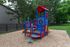Charming outdoor playground with vibrant blue and red play equipment surrounded by lush greenery, perfect for family fun.