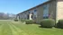 Charming brick apartment building with well-maintained landscaping, offering a serene and inviting environment.