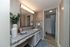 Elegant bathroom with modern granite countertop, stylish lighting, and tasteful decor leading to a shower area.