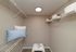 Spacious walk-in closet with modern shelving, plush seating, and elegant lighting, perfect for organized living.