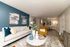 Contemporary living room with vibrant mustard armchair, modern decor, and stylish artwork, leading into a chic dining area.