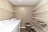 Modern laundry room with energy-efficient washer and dryer alongside ample shelving for convenient storage.