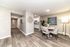 Elegant apartment dining area with modern decor, featuring stylish wood flooring, a cozy dining set, and an inviting open layout.
